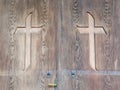 Christian cross carved in a wooden door Royalty Free Stock Photo