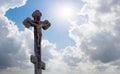 Christian cross or crucifixion in the rays of the sun on a background of blue sky with clouds, symbol of faith Royalty Free Stock Photo