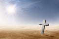 Christian cross on the desert with sun rays