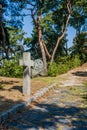 Christian cross beside flagstone walkway Royalty Free Stock Photo