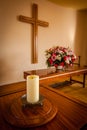 Christian cross and flowers on altar
