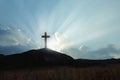 Christian cross on hill outdoors at sunrise. Resurrection of Jesus Royalty Free Stock Photo