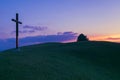 Christian cross on the hill and sunset sky in background Royalty Free Stock Photo