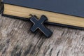 Christian Cross and Holy Bible on old wooden table Royalty Free Stock Photo