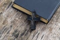 Christian Cross and Holy Bible on old wooden table Royalty Free Stock Photo