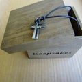 Christian cross with leather cord and wooden keepsakes box. Royalty Free Stock Photo