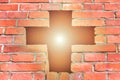 Christian cross made of bricks, a bright cross is shining through the bright sun, faith in God