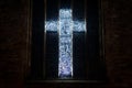 A christian cross made from lights on a church window Royalty Free Stock Photo