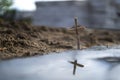 Christian cross made of wood on a background of sand