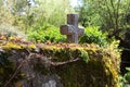 Christian cross on an old stone wall in Normandy, France