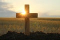 Christian cross outdoors at sunrise. Religion concept