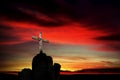 Christian cross over dark red sunset background Royalty Free Stock Photo