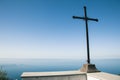 Christian cross over ocean and blue sky