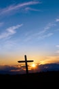 Christian cross over sunset background vertical image Royalty Free Stock Photo