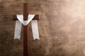 Christian cross in retro style on wooden background. Easter background. Peace symbol icon. Christian banner.