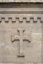 Christian cross on stone wall of old church in Bulgaria, background Royalty Free Stock Photo