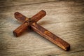 Christian Cross - symbol of the Christian faith, the main attribute of Christians. Handmade wooden cross on wooden background