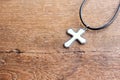 Christian cross on wooden table with window light Royalty Free Stock Photo