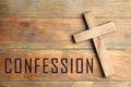 Christian cross and word Confession on wooden background, top view Royalty Free Stock Photo