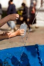 A Christian family pouring the holy water in a bottle from the Holy spring