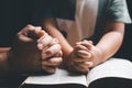 Christian family praying together concept. Child and mother worship God in home. Woman and boy hands praying to god with the bible Royalty Free Stock Photo