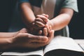 Christian family praying together concept. Child and mother worship God in home. Woman and boy hands praying to god with the bible Royalty Free Stock Photo