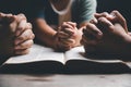 Christian family praying together concept. Child and mother worship God in home. Woman and boy hands praying to god with the bible Royalty Free Stock Photo