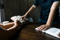 Christian family praying together concept. Child and mother worship God in home. Woman and boy hands praying to god with the bible Royalty Free Stock Photo