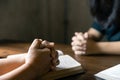 Christian family praying together concept. Child and mother worship God in home. Woman and boy hands praying to god with the bible Royalty Free Stock Photo