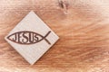 Christian fish symbol carved in wood on white vintage wooden background