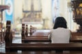 Christian girl praying in the church