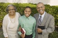 Christian Grandparents and Grandson in garden holding Bibles portrait Royalty Free Stock Photo