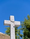 Christian granite cross on blue sky background with copy space Royalty Free Stock Photo