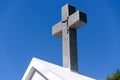 Christian granite cross on blue sky background with copy space Royalty Free Stock Photo