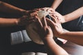 Christian group praying for globe and people around the world on wooden table with bible. Christian small group praying together Royalty Free Stock Photo