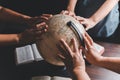 Christian group praying for globe and people around the world on wooden table with bible. Christian small group praying together Royalty Free Stock Photo