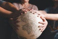 Christian group praying for globe and people around the world on wooden table with bible. Christian small group praying together Royalty Free Stock Photo