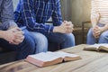 Christian group are praying together around wooden table Royalty Free Stock Photo