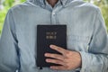 The Christian holds the Bible in his hands. Reading the bible. The concept of faith