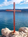 Christian iron cross on sea coast