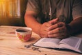Christian man Bible study. Christian hand while praying and worship for christian religion with blurred of her body background, Royalty Free Stock Photo