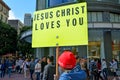 Christian man holds a Jesus Christ Love You sign during a protes