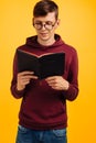 Man is reading and studying the Bible, the man is holding the Bible in his hands. Bible reading over yellow background Royalty Free Stock Photo