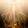 Christian nativity scene glowing in heavenly rays of light with the baby Jesus glowing in the center