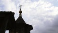 Christian orthodox church building with cross on roof top under cloudy sky low angle shot. Media. Religious place Royalty Free Stock Photo