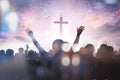 Christian people group raise hands up worship God Jesus Christ together on cross over cloudy sky background Royalty Free Stock Photo