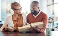 Christian, prayer or black couple reading bible book for faith, worship or bible study in kitchen or living room. Coffee Royalty Free Stock Photo