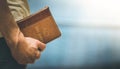 Christian preacher: Young man is holding the bible, praying Royalty Free Stock Photo