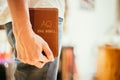 Christian preacher: Young man is holding the bible, praying Royalty Free Stock Photo