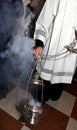 Christian priest blessing with incense during Holy Mass Royalty Free Stock Photo